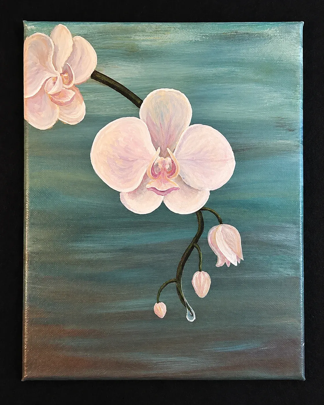 A delicate Orchid hangs whimsically over the water.